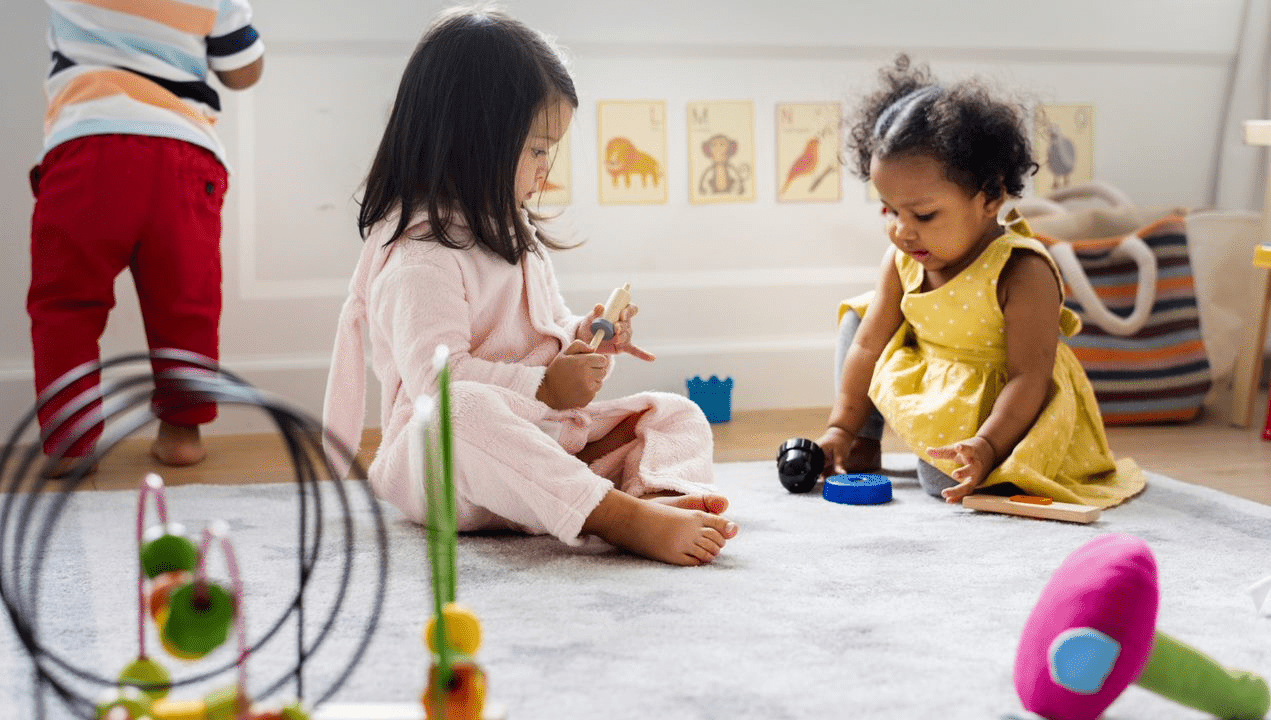 two pre-k students playing.